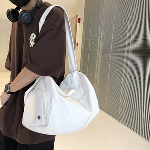 Close-up of white waterproof sports gym bag with adjustable strap and metal air vent