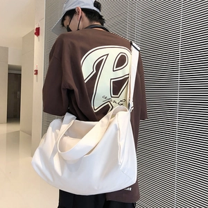 Rear view of a white large capacity gym bag with adjustable wide shoulder strap