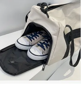 Detail view of the travel bag featuring a separate waterproof compartment for shoes