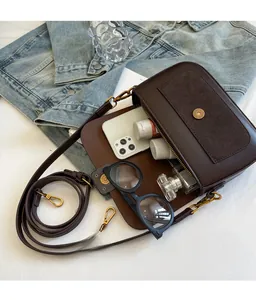 Top view of vintage brown crossbody bag showing spacious interior with daily essentials
