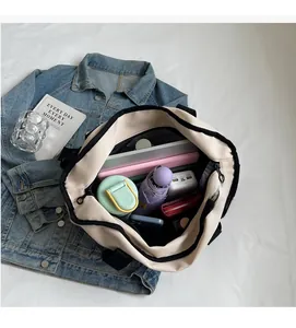 Interior view of spacious canvas tote bag showing laptop, water bottle, and daily essentials