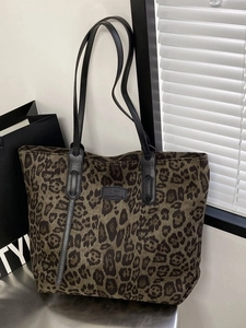 Stylish large leopard print tote bag with black handles and spacious fabric interior