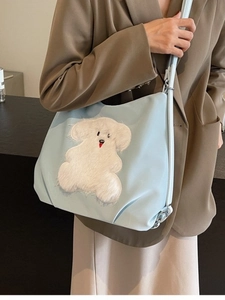 Light blue nylon tote bag with plush animal decor, casual crossbody shoulder style