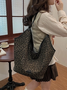Large leopard print tote bag with black trim, styled for chic autumn and winter commuting