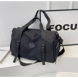 Detail of waterproof black sports bag with durable handles and adjustable shoulder strap