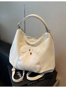 White faux leather tote bag with large 3D plush puppy applique and silver buckles