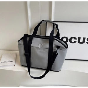 Close-up of minimalist grey yoga fitness bag with black strap and brand logo embroidery