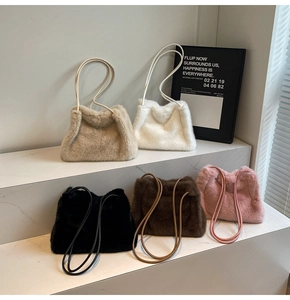 Detailed display of plush faux fur shoulder bags in five colors on marble steps
