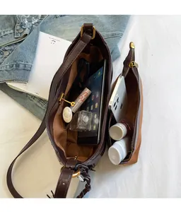 Macro view of dark brown faux leather tote with interior storage for tablet and cosmetics