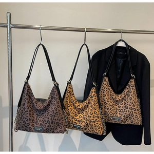 Three leopard print hobo tote bags in dark coffee, ginger, and tan with leather straps