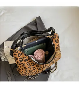 Spacious interior of leopard print tote bag holding a tablet and daily essentials