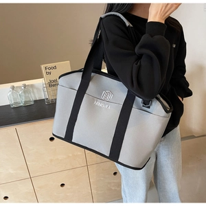 Detail of grey yoga gym bag featuring black straps and embroidered NINGJIA logo