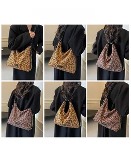 Detail view of large leopard print hobo bag with metal chain and adjustable straps