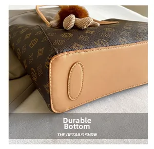 Close-up of the wear-resistant leather base and monogram texture on this vintage tote bag