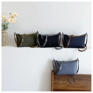 Detailed display of minimalist nylon crossbody bags in green, black, navy and blue