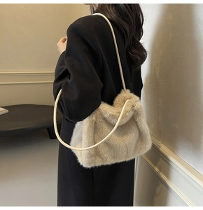 Close-up of beige faux fur shoulder bag with soft plush texture and cream slim straps
