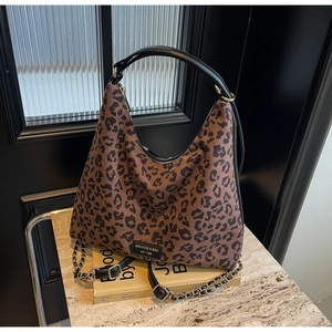 Detail shot of leopard print hobo tote showing matte suede texture and metal chain strap
