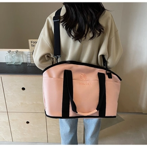 Rear view of model wearing a pink large capacity yoga bag with adjustable strap