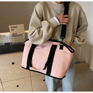 Detailed close-up of pink and black yoga bag with NINGJIA embroidery and adjustable strap