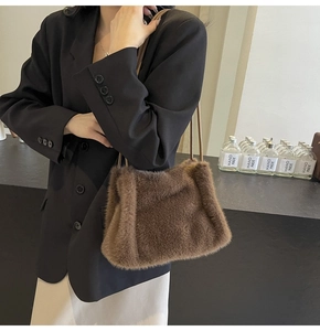 Detail of brown faux fur texture and slim leather strap on the stylish shoulder bag