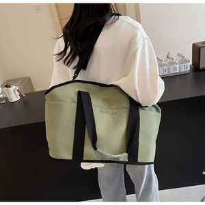 Detailed view of lightweight light green fitness bag with NINGJIA logo and shoulder strap