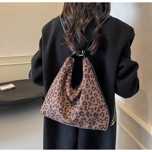 Detail of leopard print hobo bag with wide shoulder strap and gold-tone metal hardware