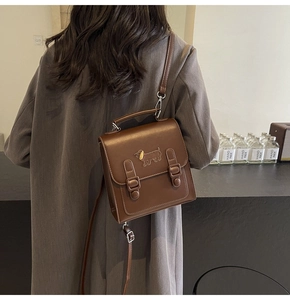 Vue détaillée du sac à dos vintage marron foncé avec ornement métallique en forme de teckel