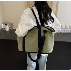 Close-up of lightweight green fitness tote bag with NINGJIA embroidery and adjustable strap