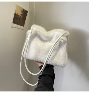 Close-up of soft white faux fur texture on a minimalist winter shoulder tote bag