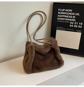 Detail of soft dark brown faux fur shoulder bag with slender light brown leather handle