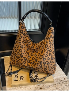 Leopard print tote bag for women with chain strap shown against a modern interior backdrop