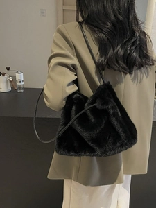 Chic black faux fur shoulder bag for women featuring a minimalist design for winter