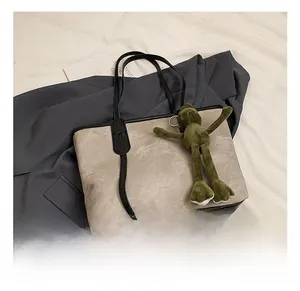 Close-up of minimalist tote bag with smooth texture and cute green frog charm
