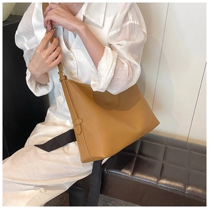 Close-up of a large camel hobo bag with lychee texture leather and adjustable strap
