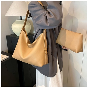 Detail of beige lychee grain leather tote and matching pouch for professional commute