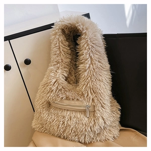 Close-up of khaki faux fur tote bag showing the zipper pocket and leather detail