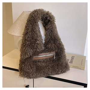 Close-up of deep brown plush tote bag featuring a practical silver front zipper pocket