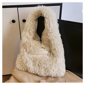 Detail of soft faux fur texture and front zipper pocket on beige shoulder tote bag