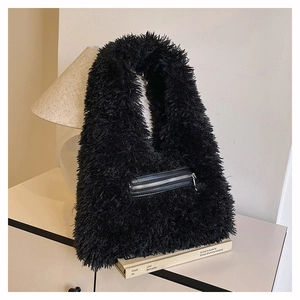 Close-up of black faux fur tote bag featuring a leather zip pocket and plush texture