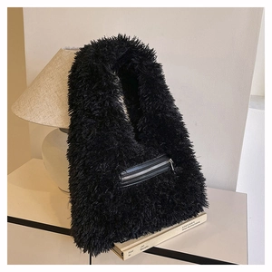 Detailed view of black plush faux fur hobo bag with front silver zipper pocket