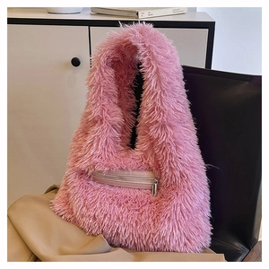 Detail of pink faux fur shoulder bag featuring a front zipper pocket and soft texture