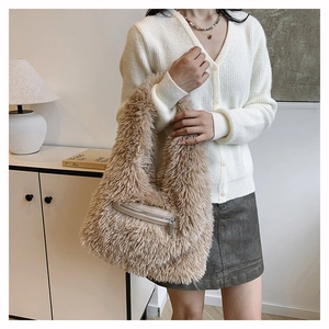 Close-up of fluffy faux fur shoulder bag in warm brown with silver zipper pocket details
