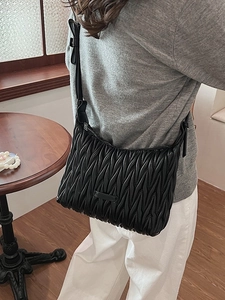Chic black pleated hobo bag with adjustable strap and delicate bow detail for women