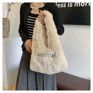 Detail of plush cream faux fur tote bag featuring a practical front zipper pocket for winter