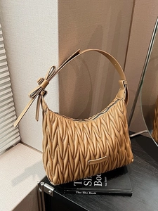 Brown matelassé pleated underarm bag with bow decoration and metal fashion plaque