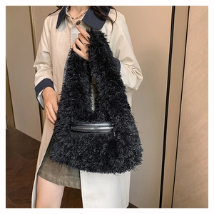 Detail of black faux fur tote bag showing the fluffy texture and silver zipper pocket