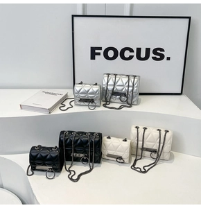 Quilted chain bags in black, white, and silver across two sizes on minimalist display