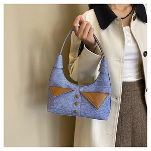Détail de l'épaule en denim bleu avec un design créatif de col en cuir marron élégant