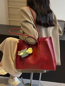 Grande borsa tote rossa retrò con ciondolo a tartaruga portata a spalla da donna