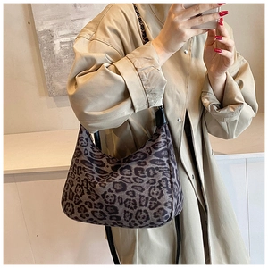 Chic leopard print hobo bag with leather chain strap shown in a styled mirror selfie
